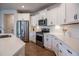 Modern kitchen features white cabinets, stainless steel appliances, and ample counter space at 405 Bramble Ln, Clayton, NC 27527