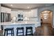 Modern kitchen with white cabinets, stainless steel appliances, and a large island at 405 Bramble Ln, Clayton, NC 27527