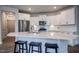 Modern kitchen features stainless steel appliances, white cabinets, and a spacious island with bar seating at 405 Bramble Ln, Clayton, NC 27527