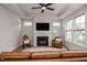 Relaxing living room featuring a fireplace and large windows for abundant natural light at 405 Bramble Ln, Clayton, NC 27527