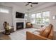 Comfortable living room featuring a fireplace and large windows overlooking the yard at 405 Bramble Ln, Clayton, NC 27527