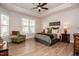 Well-lit main bedroom featuring tray ceilings and large windows with plantation shutters at 405 Bramble Ln, Clayton, NC 27527