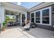 Covered patio with outdoor seating and relaxing lounge chair. Creating a perfect outdoor living space at 405 Bramble Ln, Clayton, NC 27527