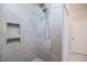Modern tiled shower with built-in niche, offering a sleek and practical showering experience at 405 Bramble Ln, Clayton, NC 27527
