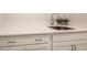 Close-up of a sleek quartz countertop sink with modern faucet and white shaker cabinets at 405 Bramble Ln, Clayton, NC 27527