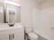 Clean bathroom features white fixtures, tile, and a vanity with black hardware at 4416 Lancashire Dr, Raleigh, NC 27613