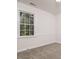 This carpeted bedroom offers natural light from a window, and features neutral wall color at 4416 Lancashire Dr, Raleigh, NC 27613