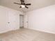 Bedroom features neutral carpet, a ceiling fan, and two white doors at 4416 Lancashire Dr, Raleigh, NC 27613