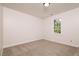 A carpeted bedroom with a window and a ceiling light fixture, offering a cozy and well-lit space at 4416 Lancashire Dr, Raleigh, NC 27613