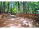 Spacious wooden deck surrounded by lush trees, perfect for outdoor entertaining and relaxation at 4416 Lancashire Dr, Raleigh, NC 27613