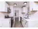 Modern kitchen with white cabinets, stainless steel appliances, and hardwood floors at 4416 Lancashire Dr, Raleigh, NC 27613