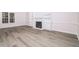 Spacious living room featuring hardwood floors, a fireplace, and built-in bookshelves at 4416 Lancashire Dr, Raleigh, NC 27613