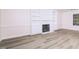 Living room features hardwood floors, a fireplace, and built-in bookshelves at 4416 Lancashire Dr, Raleigh, NC 27613