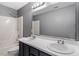 Bathroom featuring double sinks, a large mirror, and a shower and tub combination at 4733 Royal Troon Dr, Raleigh, NC 27604