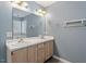 Bathroom with double sinks, a large mirror, and neutral cabinets at 4733 Royal Troon Dr, Raleigh, NC 27604
