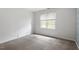 Bright bedroom with neutral carpet and a large window providing natural light at 4733 Royal Troon Dr, Raleigh, NC 27604