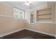 Cozy room with hardwood floors, two windows, and built-in shelving at 4733 Royal Troon Dr, Raleigh, NC 27604