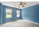 Bedroom with carpet, ceiling fan and two windows at 4733 Royal Troon Dr, Raleigh, NC 27604