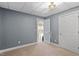 Bedroom featuring neutral carpet and gray walls adjacent to interior doorway at 4733 Royal Troon Dr, Raleigh, NC 27604