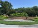 Hedingham Golf & Athletic Club sign with brick base, landscaping, and lush greenery at 4733 Royal Troon Dr, Raleigh, NC 27604