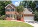 Beautiful two-story brick home with a well-maintained lawn and attached two-car garage at 4733 Royal Troon Dr, Raleigh, NC 27604