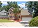 Traditional two-story brick home featuring an attached garage and a neatly landscaped front yard at 4733 Royal Troon Dr, Raleigh, NC 27604