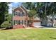 Charming two-story brick home with a well-manicured lawn and mature trees at 4733 Royal Troon Dr, Raleigh, NC 27604