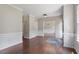 Spacious living area with hardwood floors, elegant white wainscoting, and views into other rooms at 4733 Royal Troon Dr, Raleigh, NC 27604