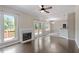 Open living room with hardwood floors, fireplace, and access to an outdoor deck at 4733 Royal Troon Dr, Raleigh, NC 27604