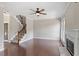Spacious living room with fireplace, hardwood floors, and staircase at 4733 Royal Troon Dr, Raleigh, NC 27604