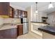 Basement wet bar featuring stainless steel fridge, tile flooring and bar seating at 4733 Royal Troon Dr, Raleigh, NC 27604