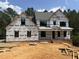 New construction home in progress, showcasing the front exterior and framing details at 49 Cloudview Ct, Pittsboro, NC 27312