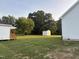 Expansive backyard featuring mature trees, a storage shed, and plenty of green space at 50 Leah Ln, Louisburg, NC 27549