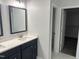 Bathroom with double vanity and view to the toilet room and walk-in closet at 50 Leah Ln, Louisburg, NC 27549