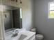 Bathroom featuring white vanity, decorative wall tile and large mirror at 50 Leah Ln, Louisburg, NC 27549