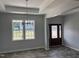Inviting entryway featuring elegant chandelier, tray ceiling and wood-look flooring at 50 Leah Ln, Louisburg, NC 27549