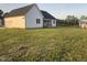 Charming farmhouse-style home set on a sprawling green lawn with a detached garage and a shed at 50 Leah Ln, Louisburg, NC 27549