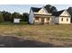 Lovely new construction home with a charming front porch and separate shed, set in a spacious, open yard at 50 Leah Ln, Louisburg, NC 27549