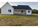Beautiful white farmhouse-style home featuring a welcoming front porch and set on a spacious green lot at 50 Leah Ln, Louisburg, NC 27549