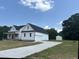 Beautiful new construction home featuring a large yard and concrete driveway at 50 Leah Ln, Louisburg, NC 27549