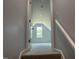 Hallway view showing carpeted stairs leading to a brightly lit upstairs room at 50 Leah Ln, Louisburg, NC 27549