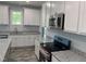 A kitchen with gray counters, white cabinets, and stainless steel appliances at 50 Leah Ln, Louisburg, NC 27549