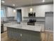 Well-lit kitchen showcasing granite countertops, stainless steel appliances, and a functional center island at 50 Leah Ln, Louisburg, NC 27549
