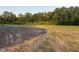 Spacious lot with paved driveway and mature trees, offering privacy and room to build at 50 Leah Ln, Louisburg, NC 27549