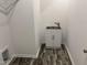 A well-organized laundry room with modern cabinets and stylish flooring at 50 Leah Ln, Louisburg, NC 27549