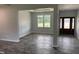 Open living room with wood-look flooring, natural light and neutral paint at 50 Leah Ln, Louisburg, NC 27549