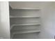 A set of white shelves is shown in a closet or pantry at 50 Leah Ln, Louisburg, NC 27549