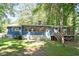 Charming home exterior with a lush backyard, inviting deck, and screened-in porch at 5124 Lazywood Ln, Durham, NC 27712