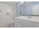 Bright bathroom with white cabinets and a large framed mirror at 5124 Lazywood Ln, Durham, NC 27712