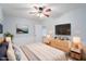 Comfortable bedroom with a TV, neutral decor, and natural light, designed for relaxation at 5124 Lazywood Ln, Durham, NC 27712